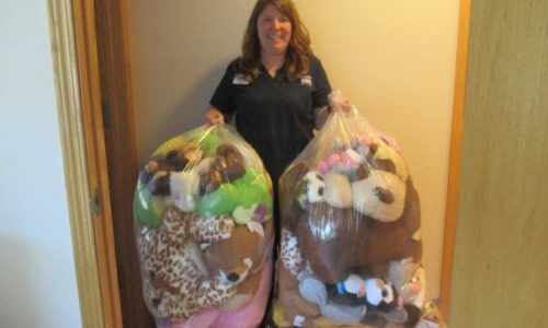 Woman holding bags filled with stuffed animals